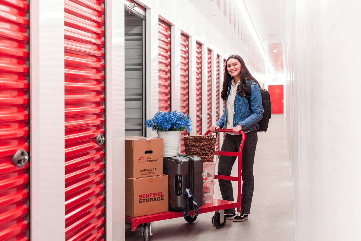 Student moving belongings into a storage unit